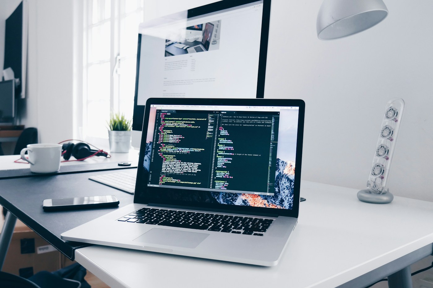 A laptop and notebook on a desk